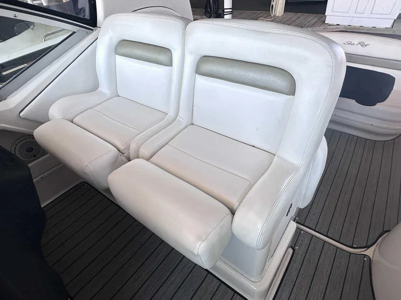 Slide: The Image of White leather seats on a 2007 Sea Ray 320 Sundancer boat interior. - 16