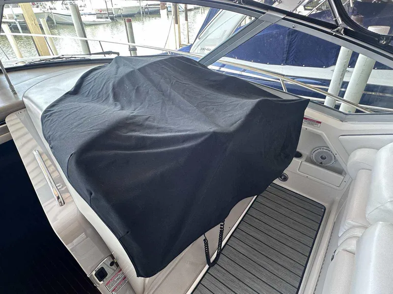 Slide: The Image of 2007 Sea Ray 320 Sundancer cockpit with black cover, docked at marina. - 17