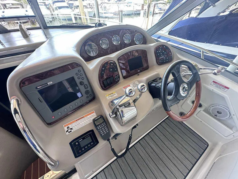 Slide: The Image of 2007 Sea Ray 320 Sundancer helm with navigation controls and steering wheel. - 18