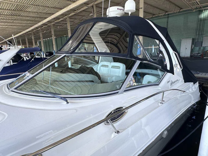 Slide: The Image of 2007 Sea Ray 320 Sundancer boat docked under a covered marina. - 2