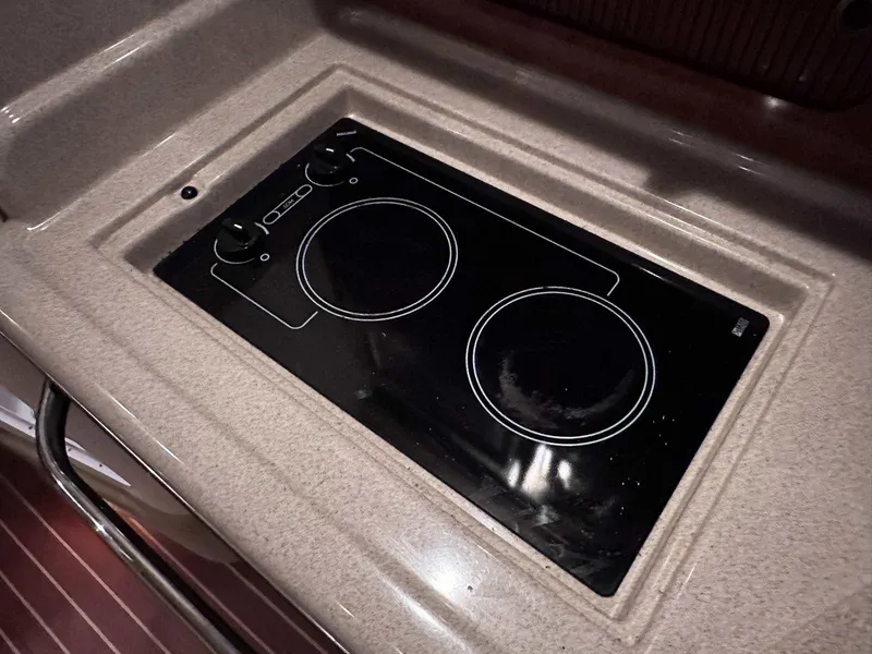 Slide: The Image of Stovetop on 2007 Sea Ray 320 Sundancer yacht, featuring a sleek black design. - 28