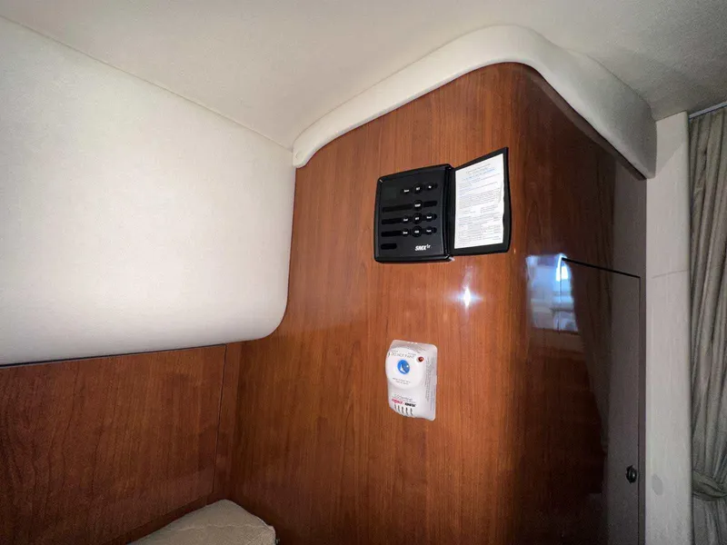 Slide: The Image of Interior of 2007 Sea Ray 320 Sundancer with wood paneling and safety equipment. - 31