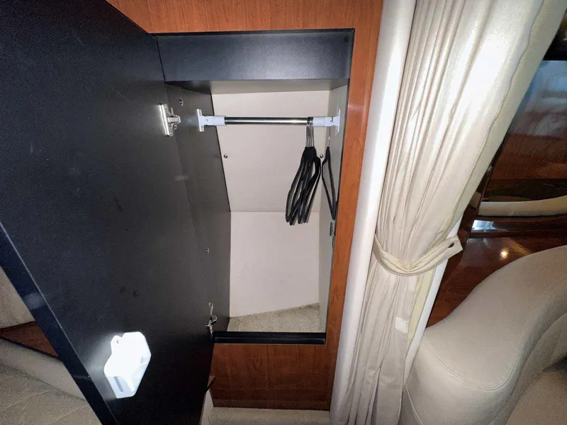 Slide: The Image of Open closet with hangers inside a 2007 Sea Ray 320 Sundancer yacht interior. - 35