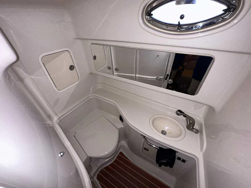 Slide: The Image of 2007 Sea Ray 320 Sundancer bathroom with sink, toilet, and mirror. - 38
