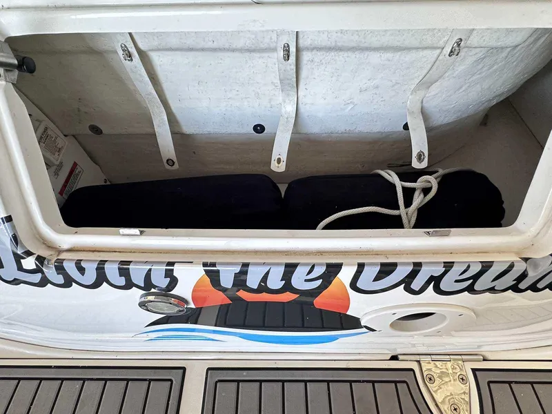 Slide: The Image of Storage compartment on a 2007 Sea Ray 320 Sundancer boat with rope and cushions. - 4