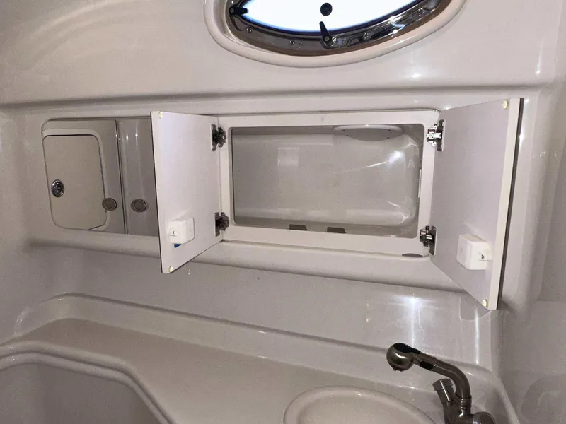 Slide: The Image of 2007 Sea Ray 320 Sundancer bathroom with open cabinet and sink. - 40