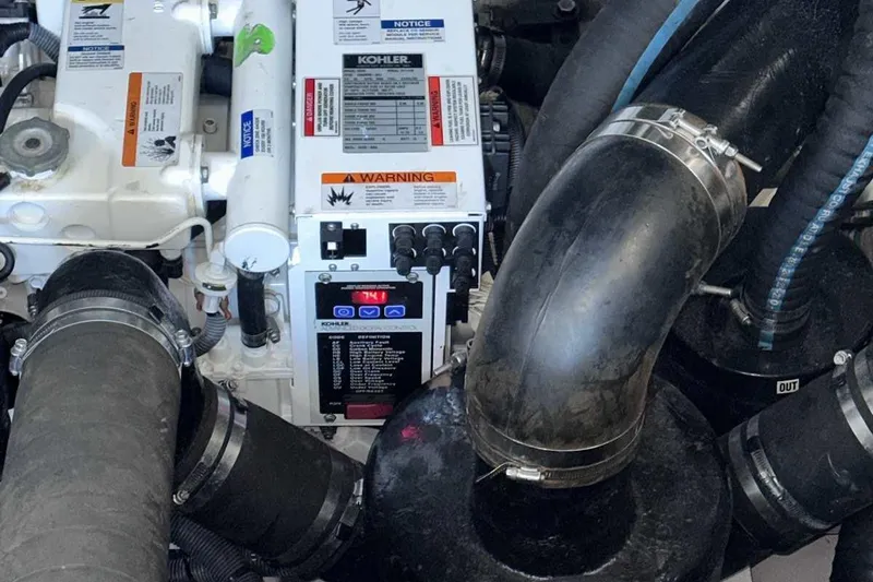 Slide: The Image of Engine compartment of a 2007 Sea Ray 320 Sundancer with Kohler generator and hoses. - 42