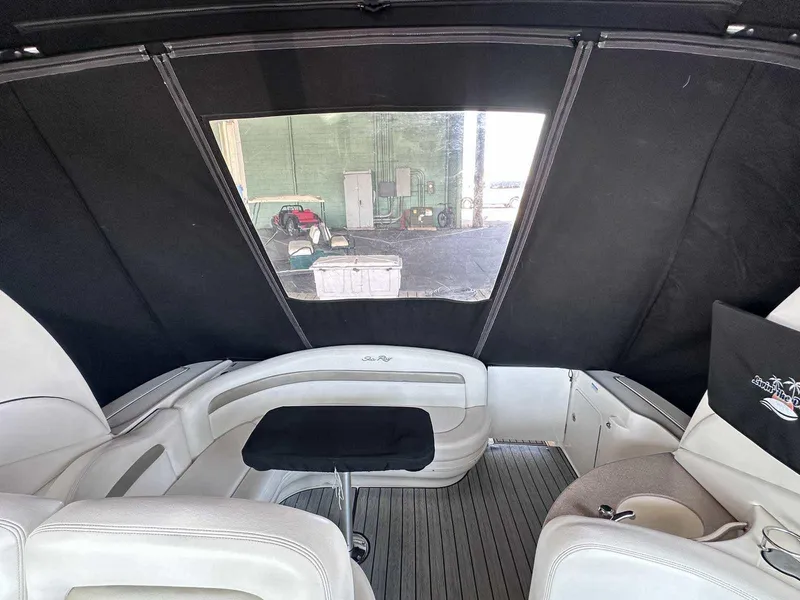 Slide: The Image of Interior of 2007 Sea Ray 320 Sundancer with seating and table, enclosed by black canopy. - 5