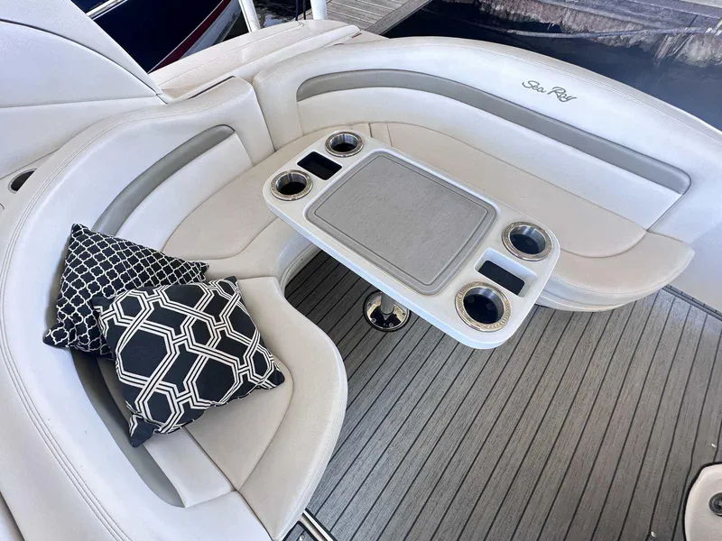 Slide: The Image of Luxurious seating area on 2007 Sea Ray 320 Sundancer with stylish cushions and table. - 8