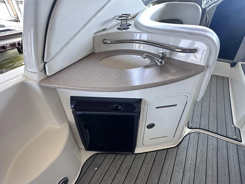 Slide: The Image of 2007 Sea Ray 320 Sundancer boat interior with sink and mini fridge. - 9