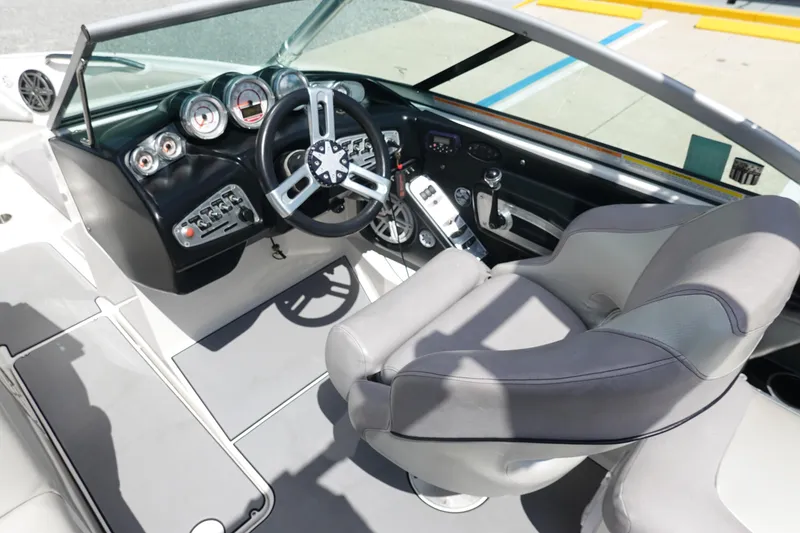 Slide: The Image of 2011 MasterCraft X15 boat interior with steering wheel and dashboard controls. - 10