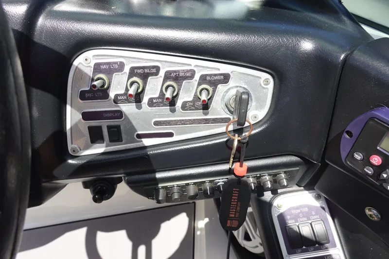 Slide: The Image of Control panel of a 2011 MasterCraft X15 boat with key and switches. - 14