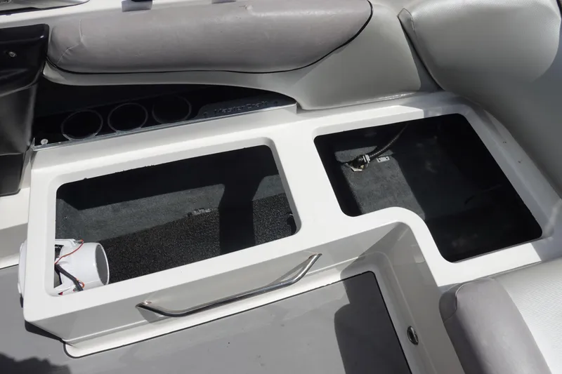 Slide: The Image of 2011 MasterCraft X15 boat interior storage compartments with gray seating. - 16
