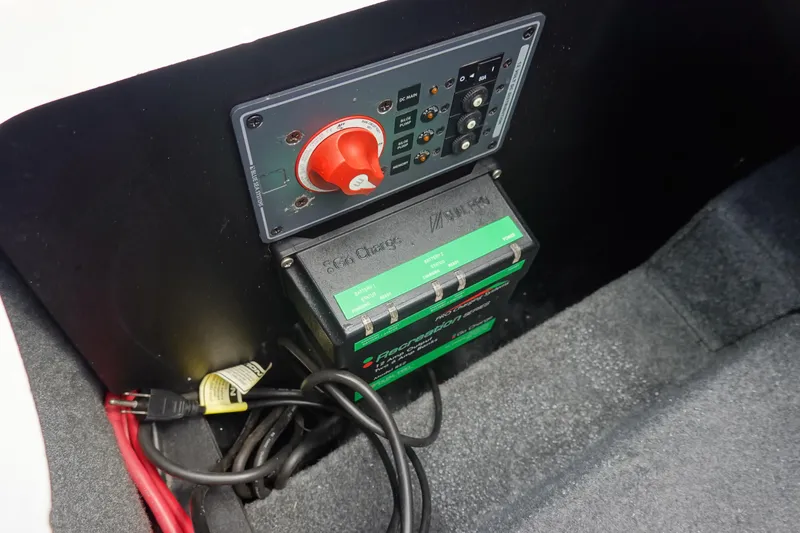 Slide: The Image of 2011 MasterCraft X15 battery switch and charger setup in boat compartment. - 18