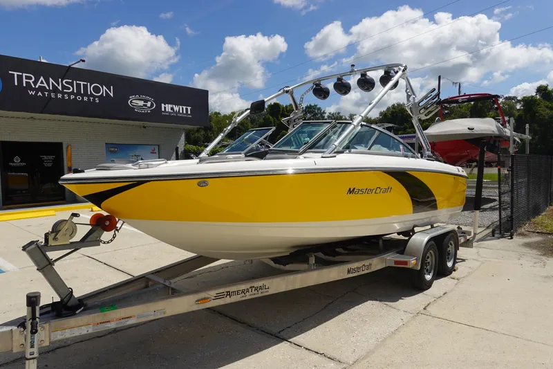 Slide: The Image of 2011 MasterCraft X15 boat in yellow on trailer at Transition Watersports. - 2