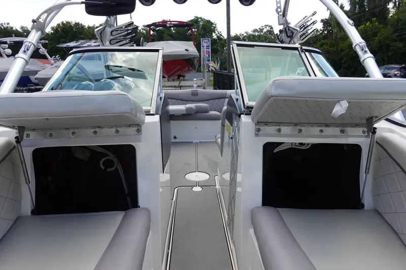 Slide: The Image of 2011 MasterCraft X15 boat interior with open storage compartments and seating. - 23