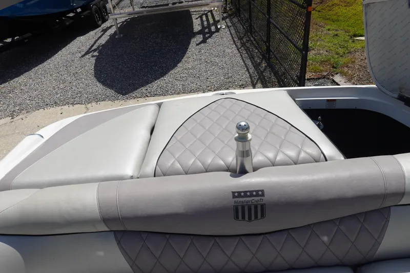 Slide: The Image of 2011 MasterCraft X15 boat interior with gray quilted upholstery and logo. - 28