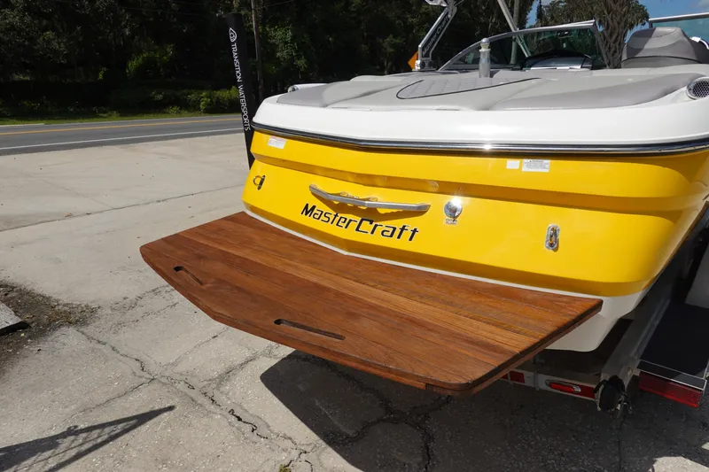 Slide: The Image of 2011 MasterCraft X15 boat with yellow hull and wooden swim platform. - 5