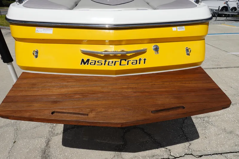 Slide: The Image of 2011 MasterCraft X15 boat with yellow hull and wooden swim platform. - 6
