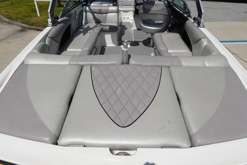 Slide: The Image of 2011 MasterCraft X15 boat interior with gray seating and diamond-patterned upholstery. - 7