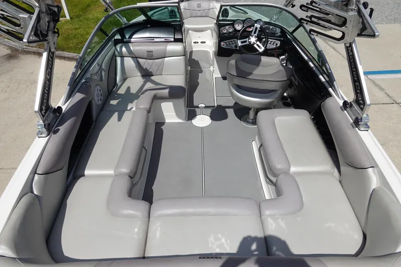 Slide: The Image of 2011 MasterCraft X15 boat interior with gray seating and modern dashboard. - 8