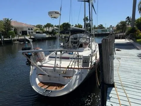 Slide: The Image of 2003 Bavaria 44 Ocean yacht docked in a sunny marina. - 2