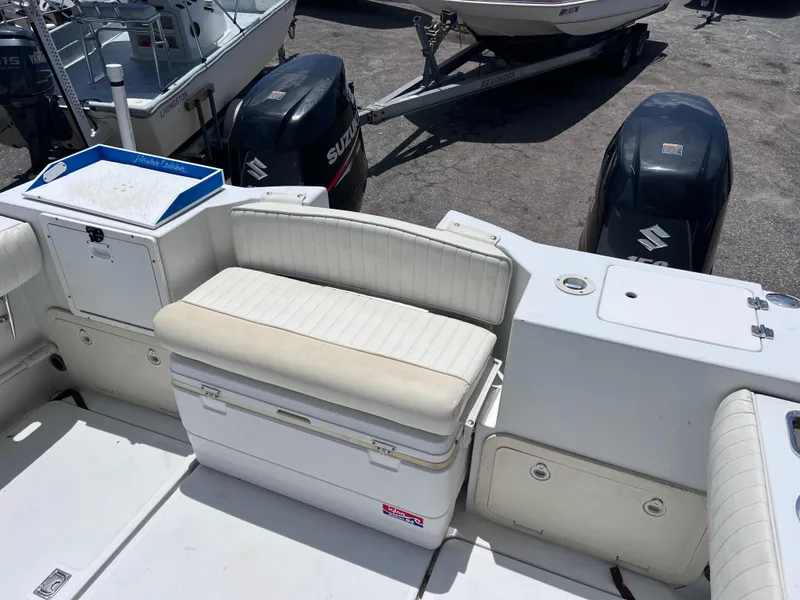 Slide: The Image of 1999 Glacier Bay 2670 Island Runner boat interior with seating and Suzuki outboard motors. - 14