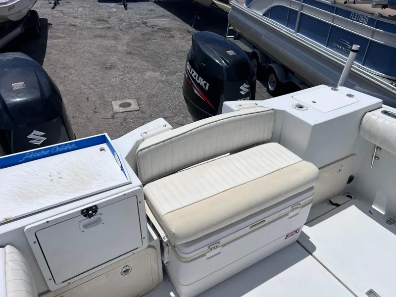 Slide: The Image of 1999 Glacier Bay 2670 Island Runner boat interior with seating and Suzuki outboard motors. - 16