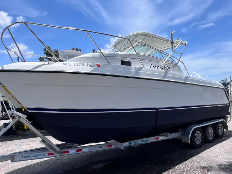 Slide: The Image of 1999 Glacier Bay 2670 Island Runner boat on trailer under blue sky. - 2
