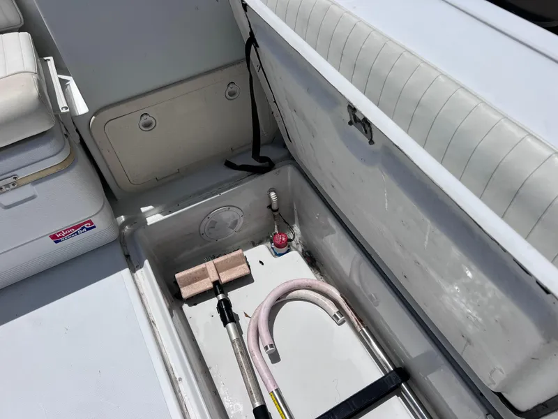 Slide: The Image of 1999 Glacier Bay 2670 Island Runner boat storage compartment with cleaning tools and equipment. - 20