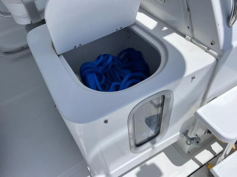 Slide: The Image of Storage compartment with blue rope on a 1999 Glacier Bay 2670 Island Runner boat. - 24