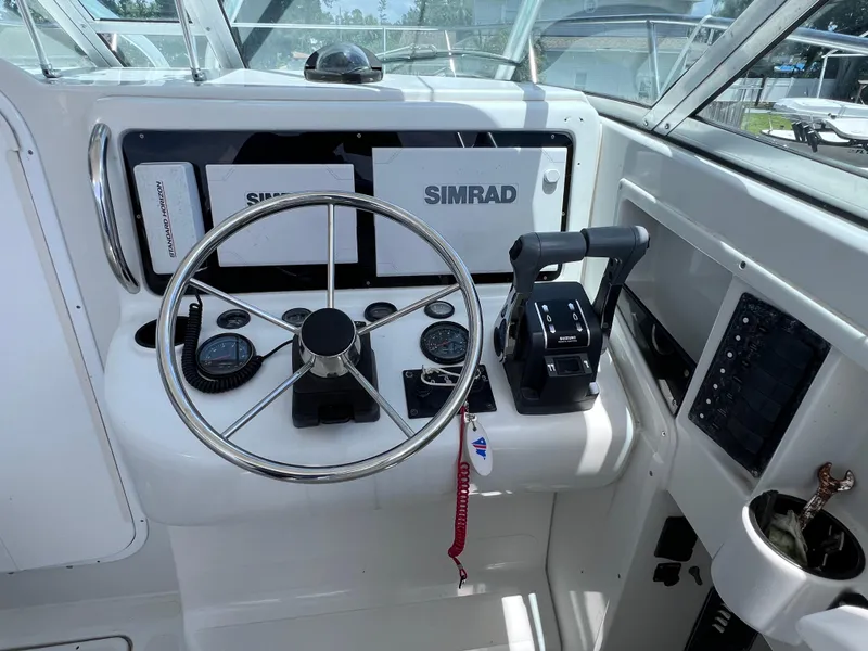 Slide: The Image of 1999 Glacier Bay 2670 Island Runner helm with Simrad electronics and steering wheel. - 26