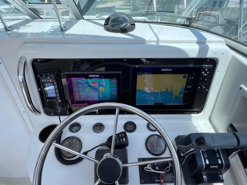 Slide: The Image of 1999 Glacier Bay 2670 Island Runner helm with Simrad navigation displays and controls. - 28