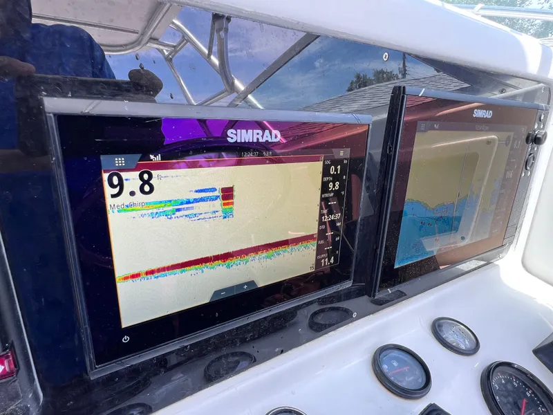 Slide: The Image of Simrad navigation screens on 1999 Glacier Bay 2670 Island Runner boat dashboard. - 29