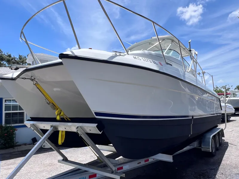Slide: The Image of 1999 Glacier Bay 2670 Island Runner boat on trailer under blue sky. - 3