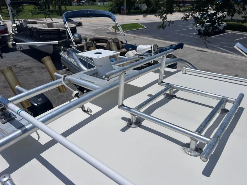 Slide: The Image of 1999 Glacier Bay 2670 Island Runner boat with metal railings and rod holders. - 33