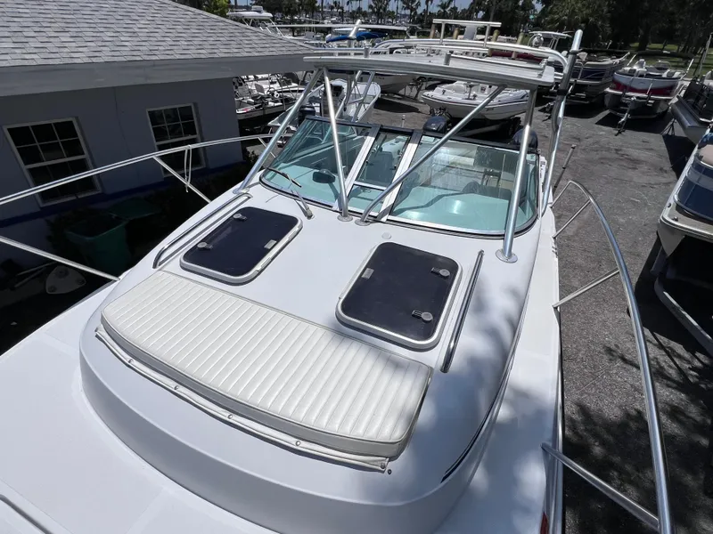 Slide: The Image of 1999 Glacier Bay 2670 Island Runner boat with dual hatches and windshield, docked outdoors. - 35