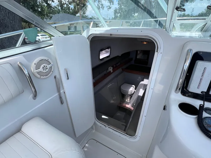 Slide: The Image of 1999 Glacier Bay 2670 Island Runner cabin interior with toilet and seating area. - 37