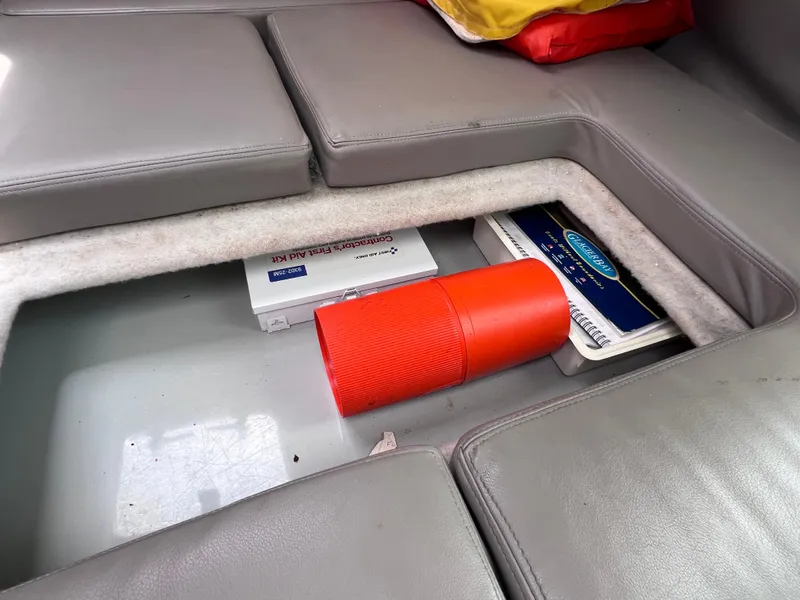 Slide: The Image of 1999 Glacier Bay 2670 Island Runner storage compartment with first aid kit and red container. - 42