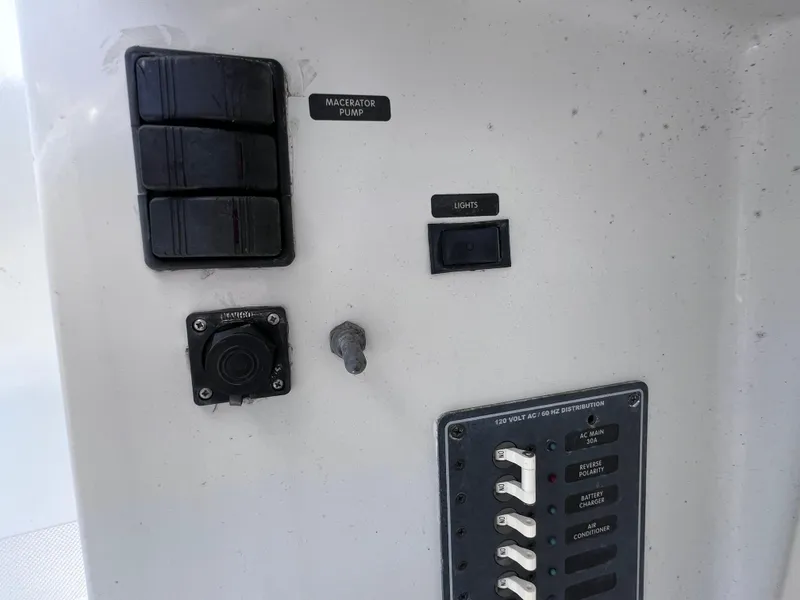 Slide: The Image of Control panel of a 1999 Glacier Bay 2670 Island Runner boat, featuring switches and labels. - 45
