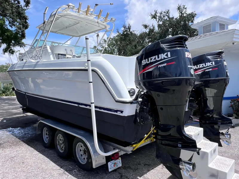 Slide: The Image of 1999 Glacier Bay 2670 Island Runner boat with dual Suzuki 150 engines on a trailer. - 6