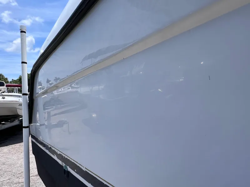 Slide: The Image of Side view of a 1999 Glacier Bay 2670 Island Runner boat under clear blue sky. - 9