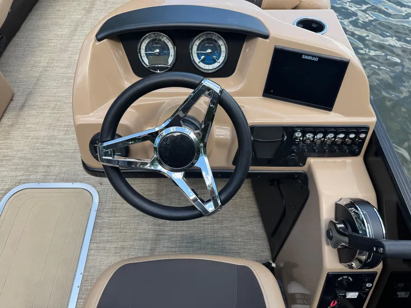 Slide: The Image of 2022 Barletta C24UC boat dashboard with steering wheel and control panel. - 3