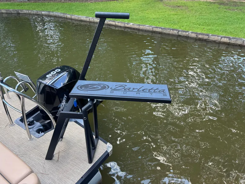 Slide: The Image of 2022 Barletta C24UC boat with Mercury engine on a calm waterway. - 6