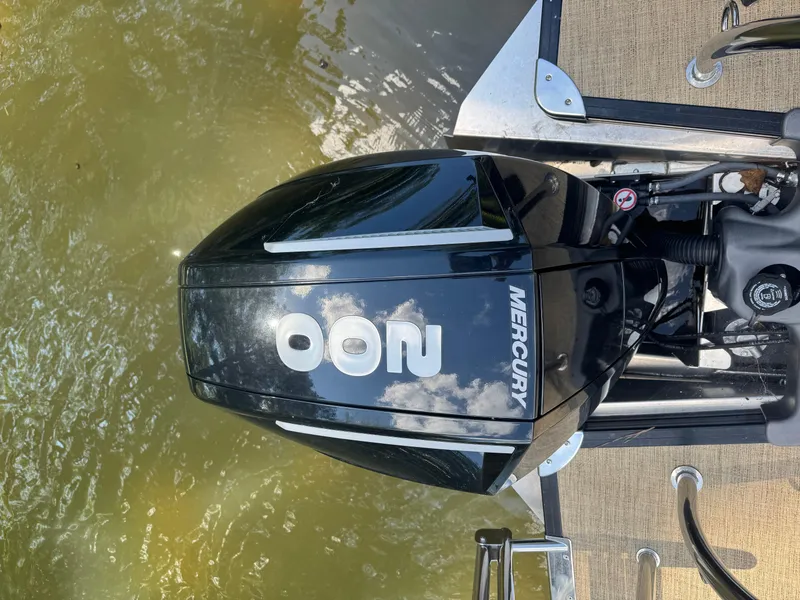 Slide: The Image of Mercury outboard motor on a 2022 Barletta C24UC boat, docked on water. - 8