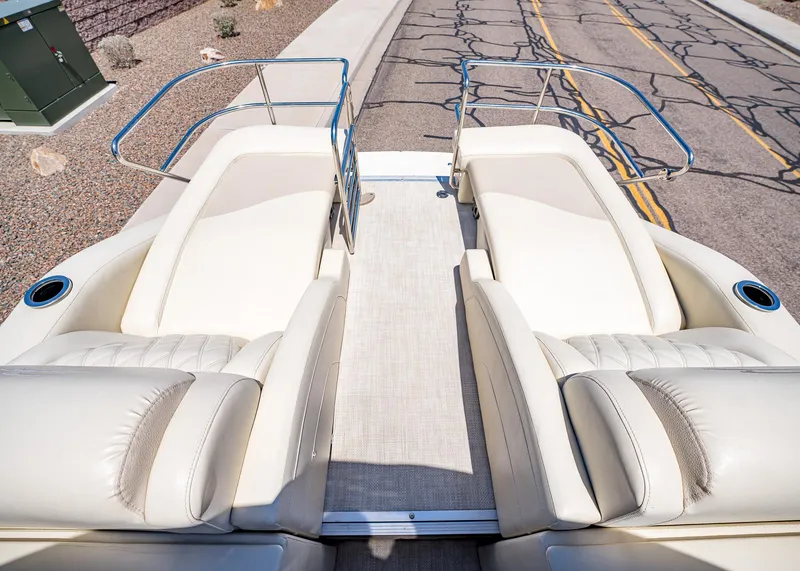 Slide: The Image of 2015 Bennington Q28 boat interior with plush seating and sleek railings. - 16