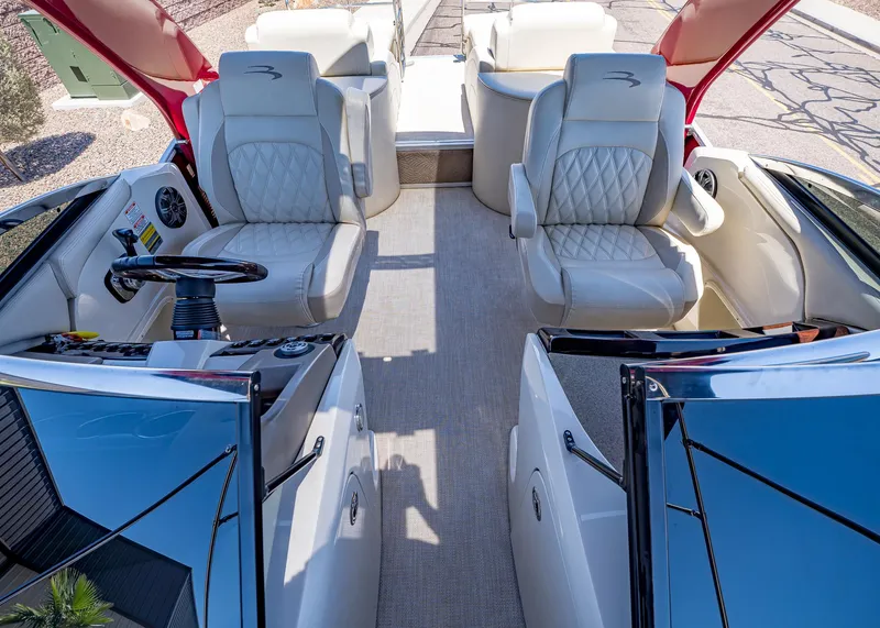 Slide: The Image of 2015 Bennington Q28 boat interior with luxurious seating and modern steering console. - 17