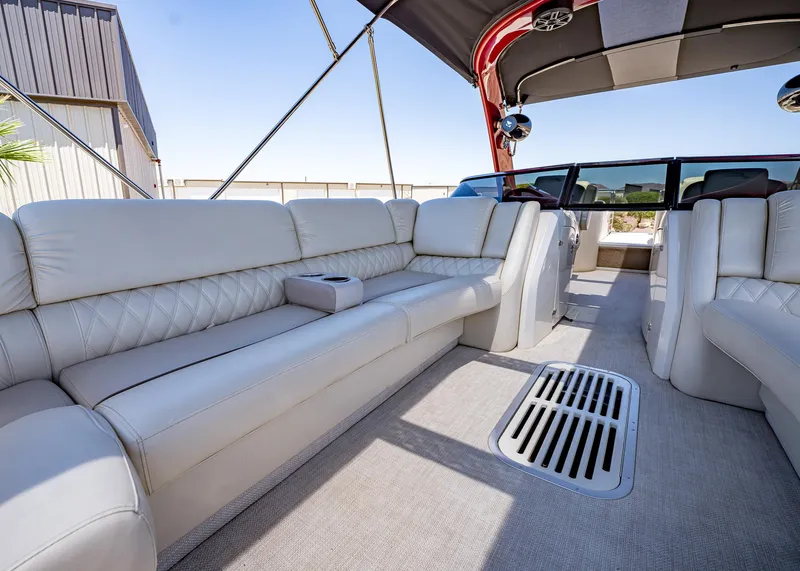 Slide: The Image of 2015 Bennington Q28 boat interior with luxurious white seating and modern design. - 20
