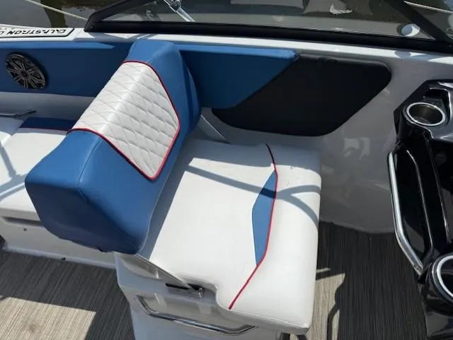 Slide: The Image of 2021 Glastron GX 210 Sport boat interior with blue and white seating, red accents. - 12