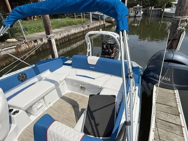 Slide: The Image of 2021 Glastron GX 210 Sport boat with Yamaha engine, docked in a marina. - 14